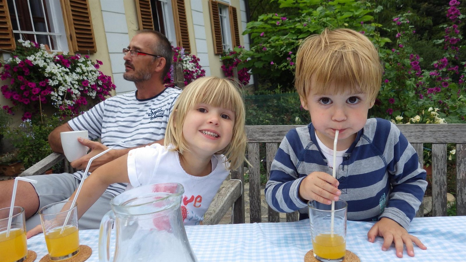 Nadia and Simon on their family farm, with Ata in the background